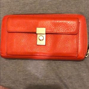 Orange DKNY zip around wallet